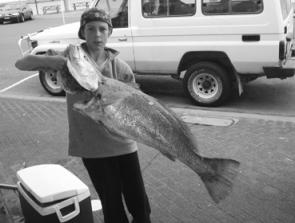Jonah Gagnuss with a 13kg jewfish caught on a soft plastic from the northern breakwall at Harrington.